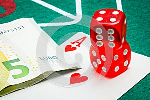 Two red dice with euros