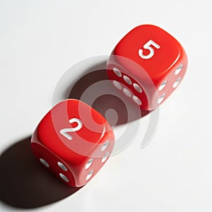 Two red dice rolling on a surface