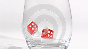 Two red dices in a super slow motion rebounding in glass