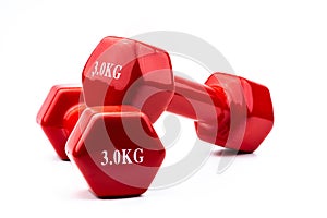 Two red dumbbells isolated on white background with copy space for text. 3.0 kg dumbbell. Weight training equipment. Bodybuilding