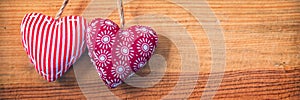 Two red fabric hearts on old panoramic wood background valentines day web banner