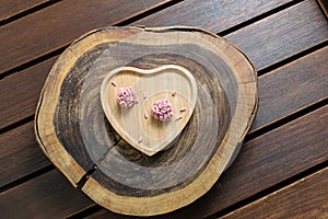 Two red fruit brigadiers on a wooden board photo