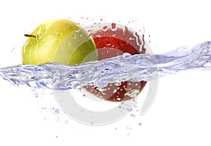 Two red and green apples dropped in water