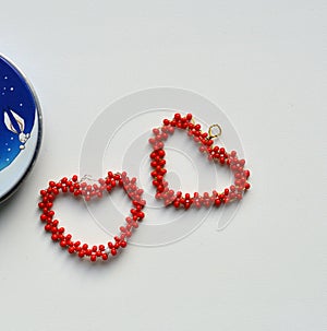 Two red hearts from beads valentine& x27;s on a white background