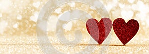 Two red hearts on bokeh background