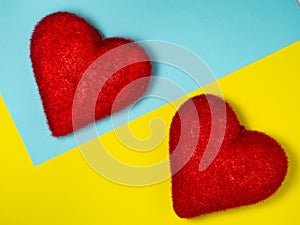 Two red hearts on colored paper. Postcard for valentine\'s day. Happy valentine\'s day greetings. Romantic background