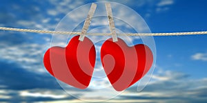 Two red hearts hanging on a clothesline, blue sky background. 3d illustration