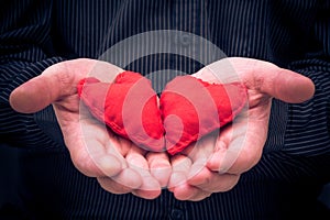 Two red hearts held male hands