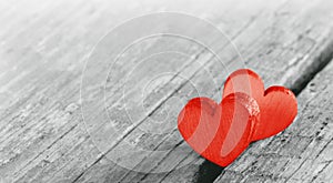 Two red hearts on old wood