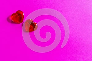 Two red hearts on pink background for Valentine`s Day, weddings, etc.
