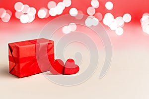 Two red hearts and red gift box on a white background with lights. Valentines day, love, romance, dating, gift present,