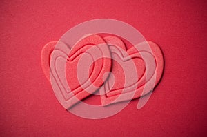 two red hearts on red paper background - Valentine`s day concept