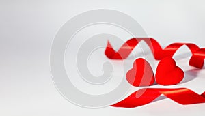 Two red hearts and red ribbon on white background. Concept of congratulations for Valentine`s day. Banner. Copy space