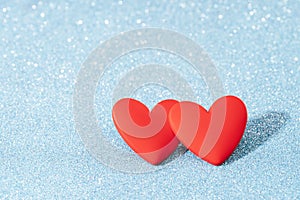 Two Red hearts valentine day greeting card. Bokeh blue background.