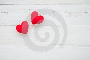 Two red hearts on white wooden background - valentines day concept