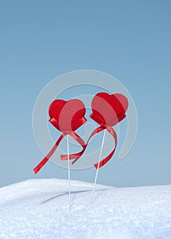 Two red hearts on winter snow. Couple in love walking outdoor. Happy Valentine greeting card. Tugetherness, friendship