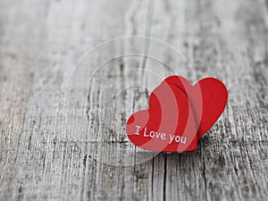 Two red hearts on wood background