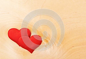 Two red hearts on a wooden board