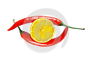 Two red hot chilly peppers and lemon slice isolated on white