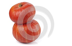 Two red kuri squash are Isolated on a white