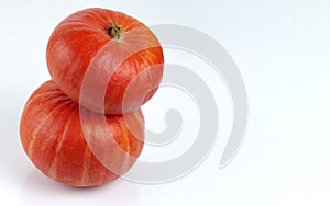 Two red kuri squash isolated on a white