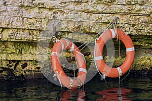 Two red lifesavers attached to a cenote wall in Greece