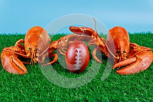 Two red lobsters as a game contestant with a football ball