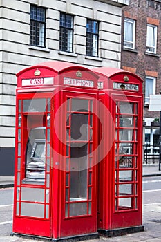 Two red phone booths on the street.. London