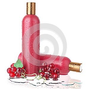 Two red plastic shampoo and hair conditioner bottles, shower gel and lotion in water drops on white background isolated close up