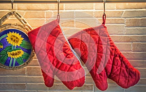 two red potholders and trivet hanging in a modern classic cuisine