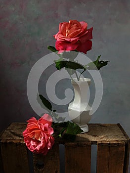 Two red roses in vintage atmosphere