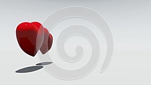 Two red rotating hearts on a white background