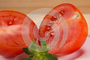 Two red sliced tomates close