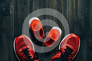 Two red sport running shoes or sneakers of mother or father and