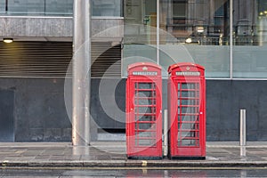 The two red telephone boxes , famous icons of London,