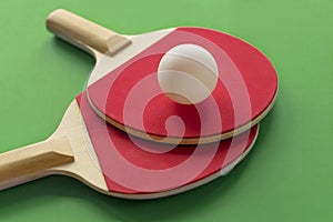 Two red tennis rackets with white ball on it