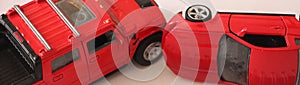 Two red toy cars ccidenr wide banner. Car insurance concept