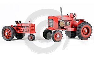 Two Red Toy Tractors Isolated photo