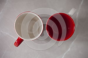 Two red and white coffee cups
