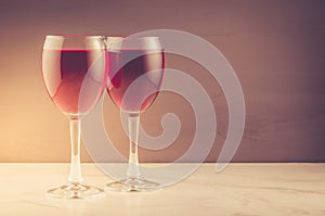 Two red Wine glass Two red Wine glass on a brown background.