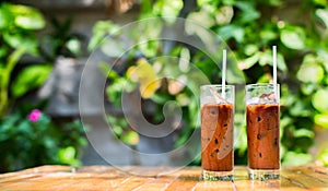 Two refreshing iced coffees in a garden cafe on a beautiful summer day. photo