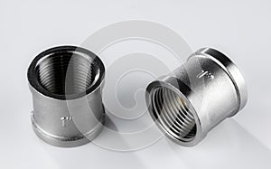 Two regular couplings of white metal with an internal thread