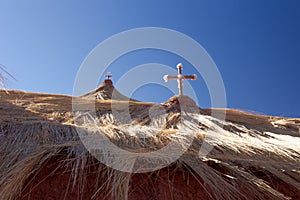 Detail of two religious crosses on top of. Taken during springtime at Village of Machuca at Los Flamencos national reserve in