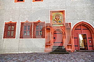 Two Renaissance doorways painted bright coral color with Gothic