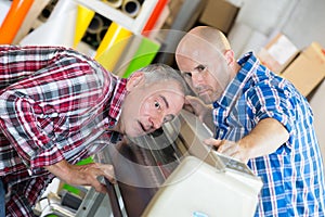 Two repairmen in workshop
