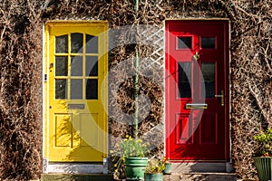 Two residential front doors, one yellow, one red. Colorful doors in Ireland