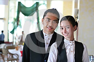 Two restaurant staff at work