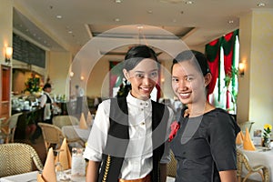 Two restaurant staff at work