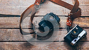 Two Retro Film Camera On Colorful Wooden Surface