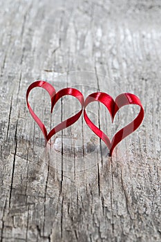 Two ribbon hearts on wood